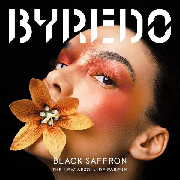An eye-catching ad showcasing Byredo's Black Saffron fragrance, utilizing a close-up of a model with an orange flowe