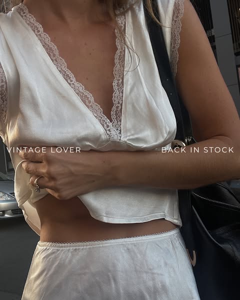 This ad features a woman wearing a silky white two-piece set. Text overlayed on the image reads "Vintage Lover"