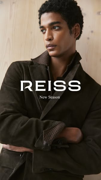 This is a static image ad featuring a man wearing a dark-colored jacket from the brand REISS.