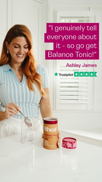 The image ad features a woman preparing a Rheal Balance Tonic drink in her kitchen. She is smiling and appears to be enj
