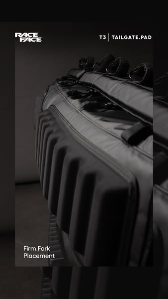 This ad highlights the Race Face T3 Tailgate Pad, emphasizing its firm fork placement for secure bike transport. The vis