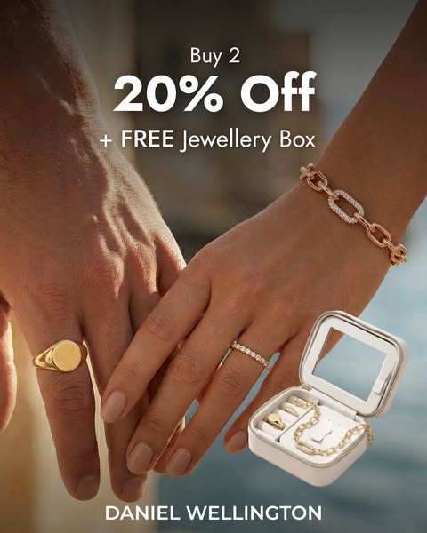 This ad promotes Daniel Wellington jewelry, showcasing rings and a bracelet on two people holding hands. It highlights a