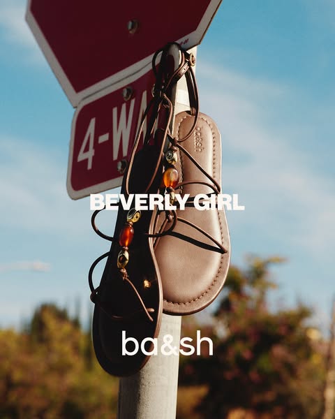 The image features ba&sh sandals hanging on a traffic sign. It's a simple and visually striking ad, focusing on 