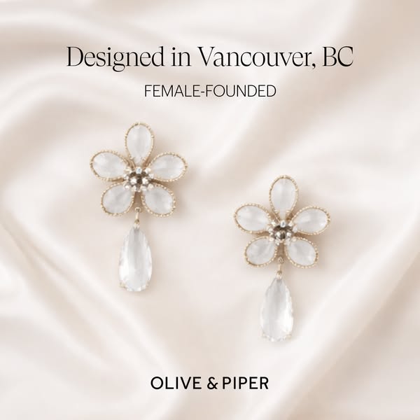 Image ad showcasing flower-shaped earrings with dangling teardrop pendants from Olive & Piper. The ad highlights the