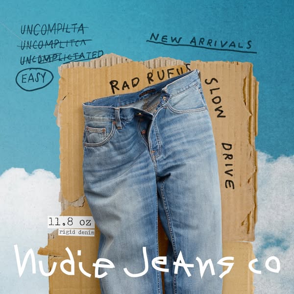 This image ad for Nudie Jeans Co. uses a cloud background and cardboard prop to create a casual, deconstructed aesthetic