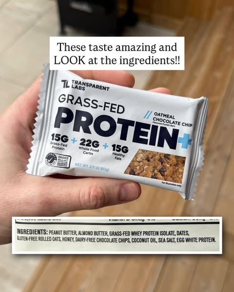 This ad features a close-up of a hand holding a Transparent Labs Grass-Fed Protein bar, with text overlay highlighting t