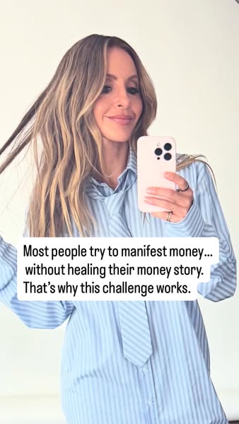A woman is taking a selfie video and describing why a certain challenge works to manifest money.