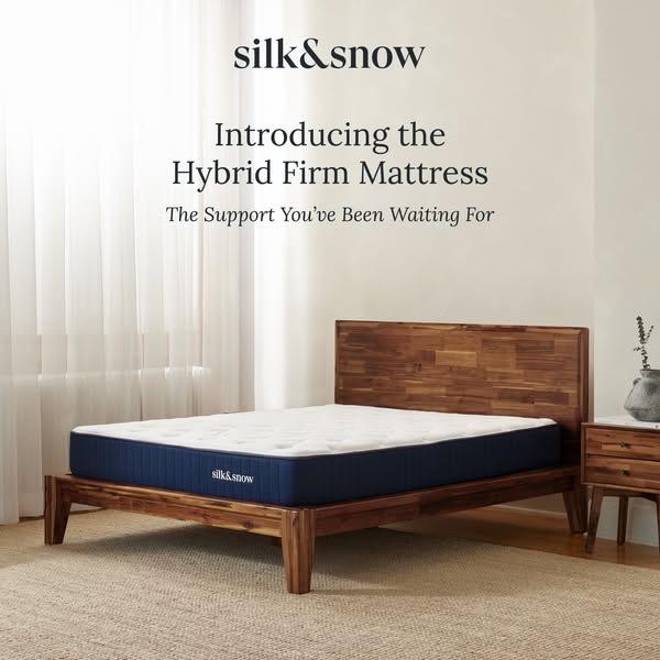 This image ad showcases a Silk & Snow hybrid firm mattress on a wood bed frame in a bright, airy bedroom setting. Th