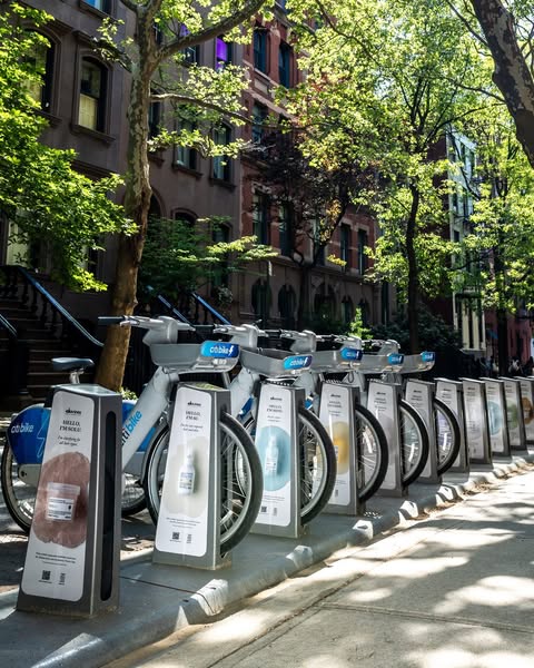 An image ad for cocokind skincare products displayed at a Citi Bike rack. It features various cocokind products being pr