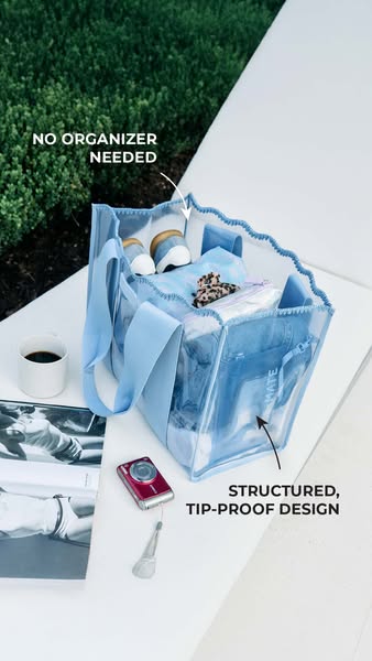 This ad showcases a clear tote bag with a structured, tip-proof design that doesn't require an organizer.