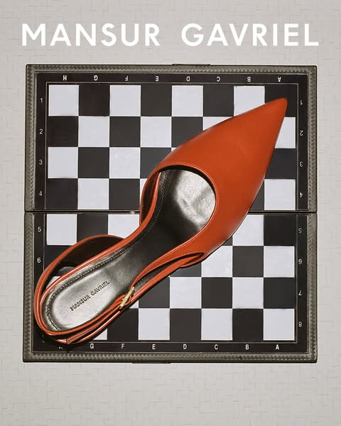 This ad showcases a single Mansur Gavriel slingback heel, styled on a chessboard.