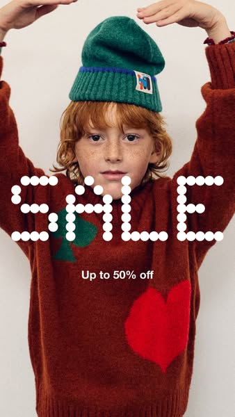 This image ad features a child wearing a sweater and hat, advertising a sale of up to 50% off.
