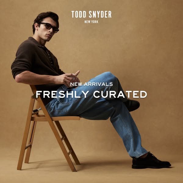 This ad features a sharply dressed model sitting in a chair wearing clothing from Todd Snyder's new arrivals.