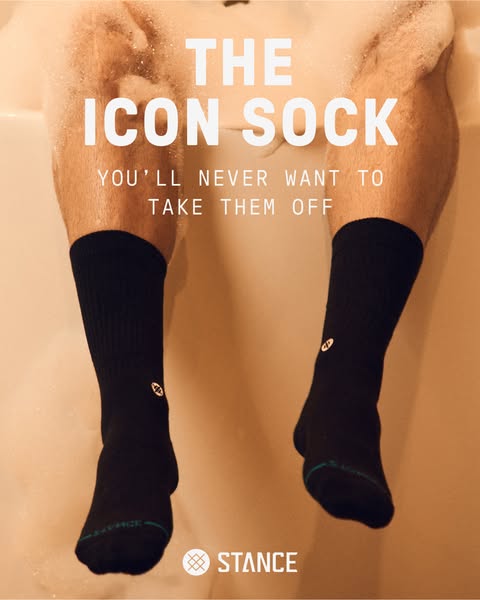 The image ad showcases a person relaxing in a bathtub with black Stance socks on. The ad copy emphasizes the comfort of