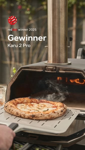 The ad showcases a pizza being prepared in the Ooni Karu 2 Pro pizza oven, highlighting its award-winning design and coo
