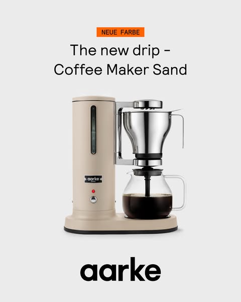 A static image ad for Aarke featuring a coffee maker in a new 'Sand' color.