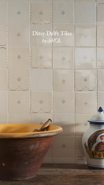 This ad showcases deVOL's Ditsy Delft Tiles in a kitchen setting, emphasizing their handcrafted and decorative quali