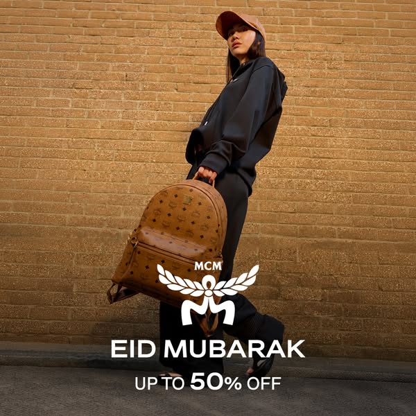 This image ad for MCM promotes a sale of up to 50% off in honor of Eid Mubarak, and features an MCM logo and a person we