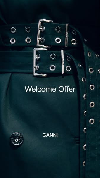 This image ad for GANNI features a dark green belted garment and promotes a welcome offer.