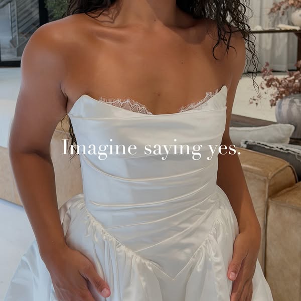 This image ad showcases a woman wearing a white lace wedding dress. The ad is centered around the theme of envisioning s