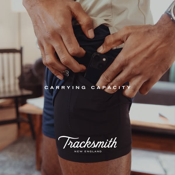 This ad showcases Tracksmith running shorts. The focus is on the product's carrying capacity, featuring a close-up o
