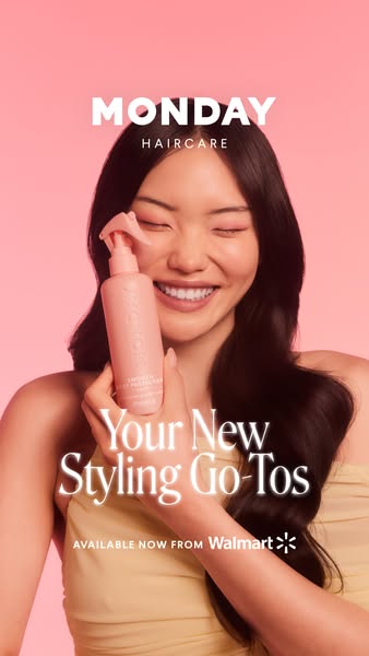 This image ad for MONDAY Haircare features a woman smiling with her eyes closed as she holds a bottle of Smooth Heat Pro
