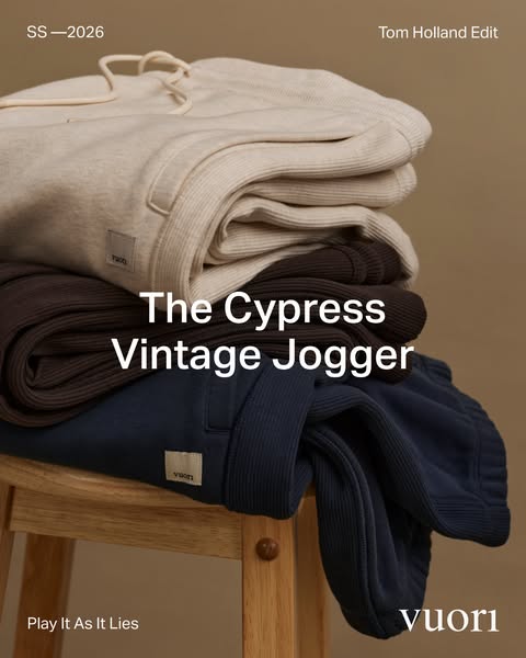 This image ad features three pairs of Vuori Cypress Vintage Joggers stacked on a wooden stool. The ad highlights a speci