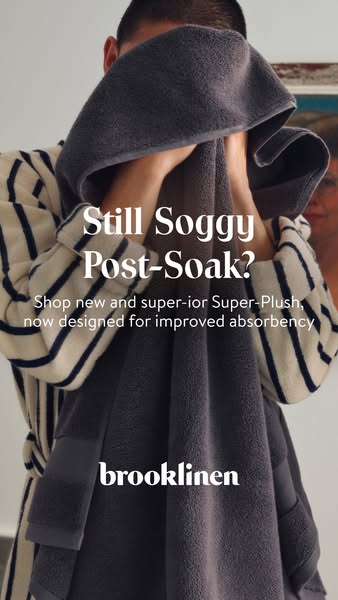 This Brooklinen image ad focuses on the quality and high absorbency of their bath towels. The towel is held up to the ca