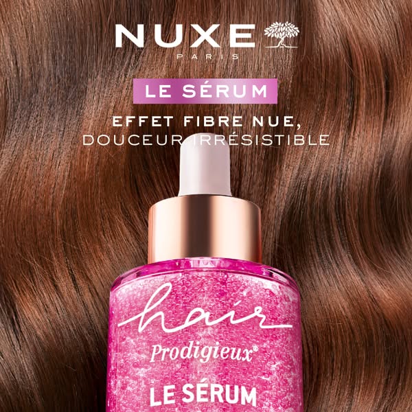 This image ad focuses on the Nuxe Hair Prodigieux Le Serum. The image highlights the texture of the hair serum and bottl