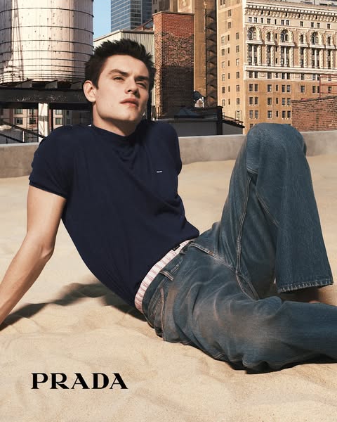 A print advertisement for Prada features a single model in the brand's apparel.