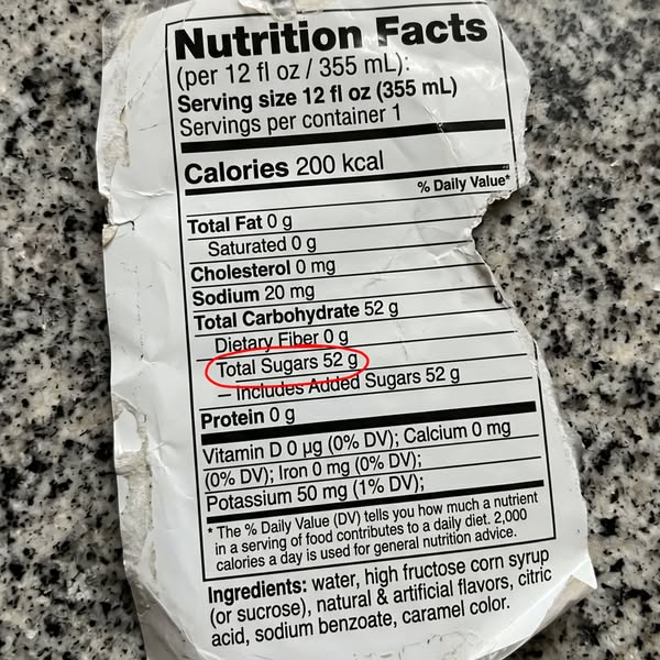 This ad uses a close-up screenshot of a nutrition facts label to highlight the high sugar content of a drink.