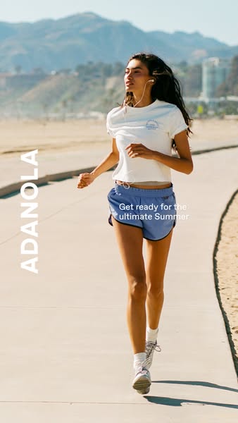 An athletic woman is shown running outdoors in an ad for Adanola apparel. She is wearing a white T-shirt and blue runnin