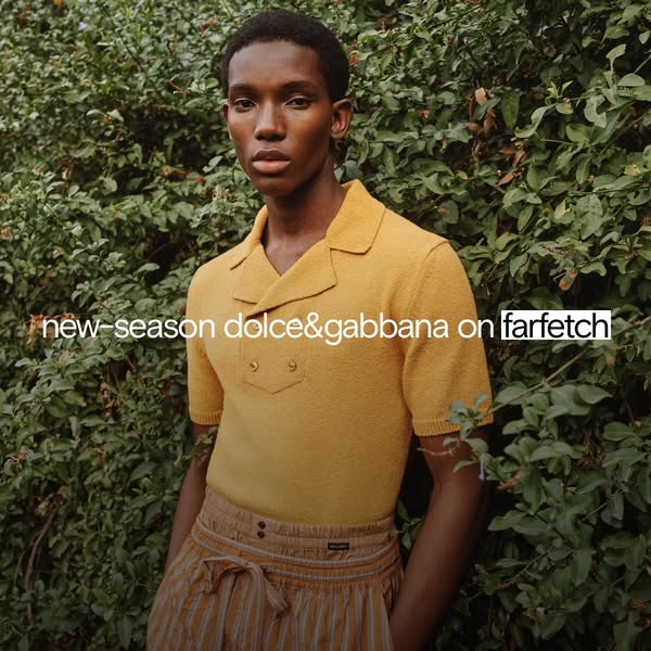 An ad for new season Dolce & Gabbana apparel available on Farfetch. The ad features a young, dark-skinned man wearin