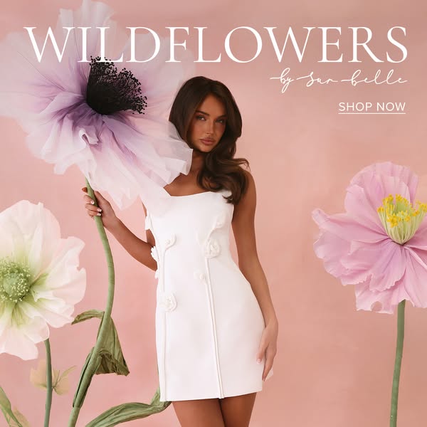 This image ad by San Belle features a woman in a white dress standing next to giant flowers. The ad is designed to draw 