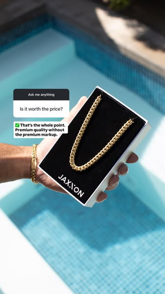 A close-up image of a gold chain necklace presented in its box, with a caption above from a user asking if it's wort