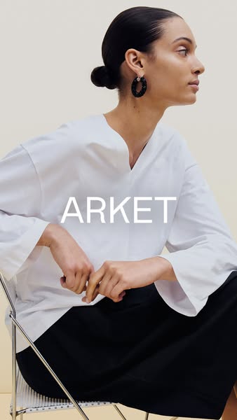 This image ad for ARKET presents the brand through a minimalist, high-fashion aesthetic. The ad features a model wearing