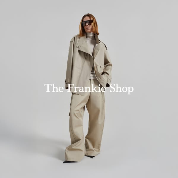 An advertisement by The Frankie Shop features a model in a neutral-toned outfit including a trench coat and baggy pants.