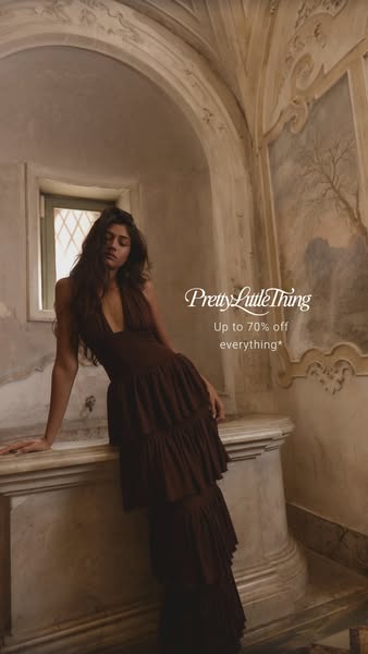 This image ad from PrettyLittleThing features a model wearing a brown, multi-tiered halter dress in an ornately decorate