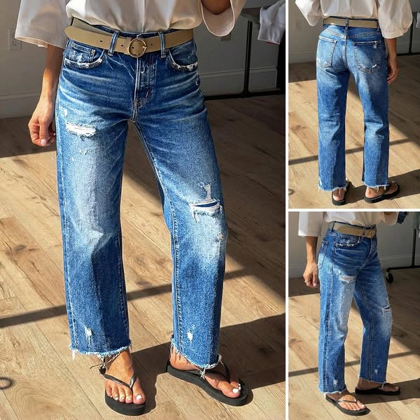 This image shows a pair of distressed jeans being modeled.
