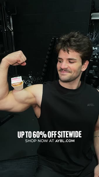 This ad promotes AYBL clothing with a discount offer. It shows a man flexing his arm with a cupcake photoshopped on his 