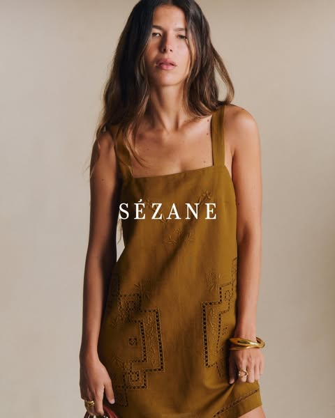 A woman is shown wearing a brown dress and gold jewelry by Sézane. The brand name is displayed in the center of the imag