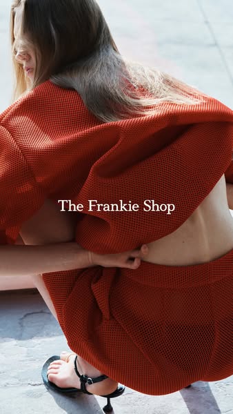 This image ad features a woman squatting and wearing a matching coral-colored net-like outfit. The brand, The Frankie Sh