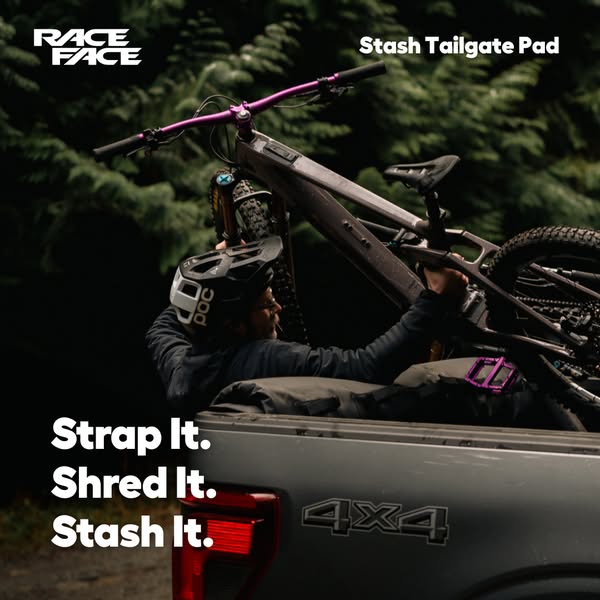 An image promoting Race Face's Stash Tailgate Pad. A person is shown securing bikes on the pad in the back of a truc