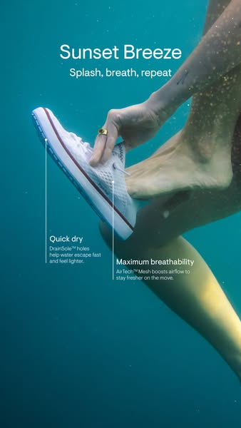 An underwater shot showcases a woman wearing white tennis shoes. The shot focuses on the shoe and two features: quick-dr