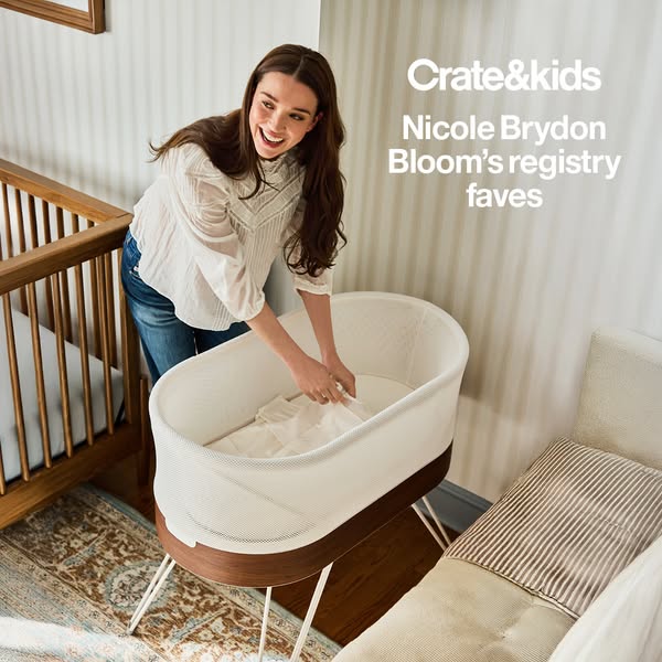 The image ad promotes Crate & Kids, and spotlights Nicole Brydon Bloom's registry favorites, featuring a bassine