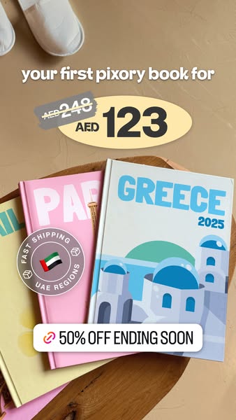This Pixory ad promotes a discount on a customer's first travel photo book. The image features a stack of Pixory tra