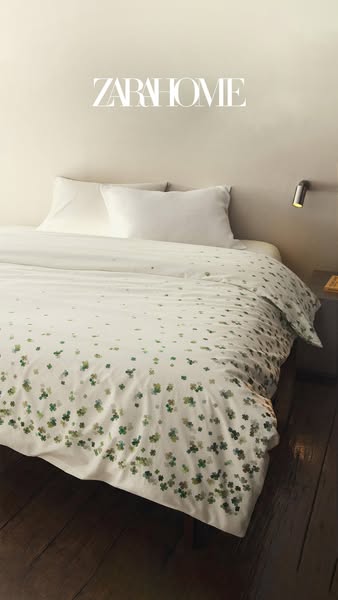 This image ad showcases a Zara Home bedspread and pillow set with a light-colored background.