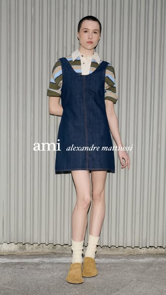 This image ad features a woman in a denim dress by Ami Alexandre Mattiussi. The ad highlights the brand name.
