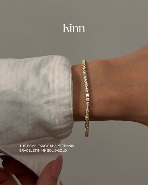 This ad features a gold tennis bracelet. The image is a close-up shot of the bracelet on a person's wrist, showcasin