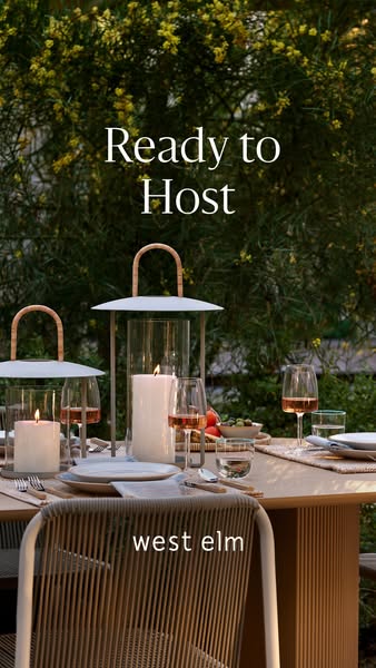 An outdoor dining table is set with dinnerware, glasses, silverware, and a lit candle in a lantern. Text overlay reads, 